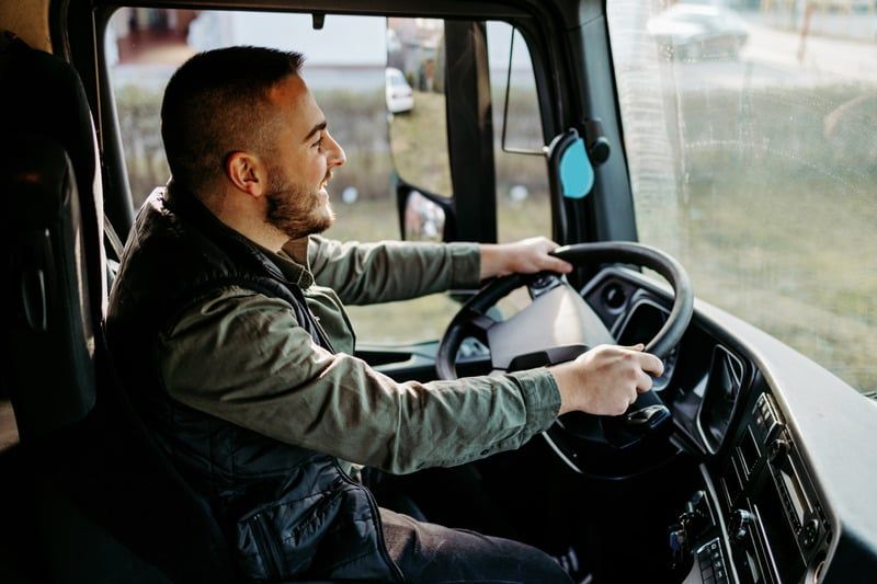 A driver behind the wheel of a truck